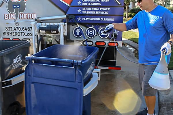 A bin hero sanitizing a bin after a cleaning